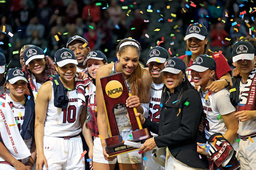 A'ja Wilson and head coach Dawn Staley of the South Carolina Gamecocks hold the NCAA trophy and celebrates with their team after winning the championship game against the Mississippi State Lady Bulldogs of the 2017 NCAA Women's Final Four