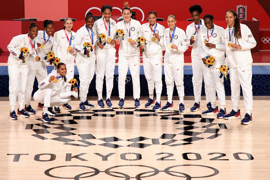 Team US pose with their gold medals during the Women's Basketball medal ceremony at the 2020 olympics