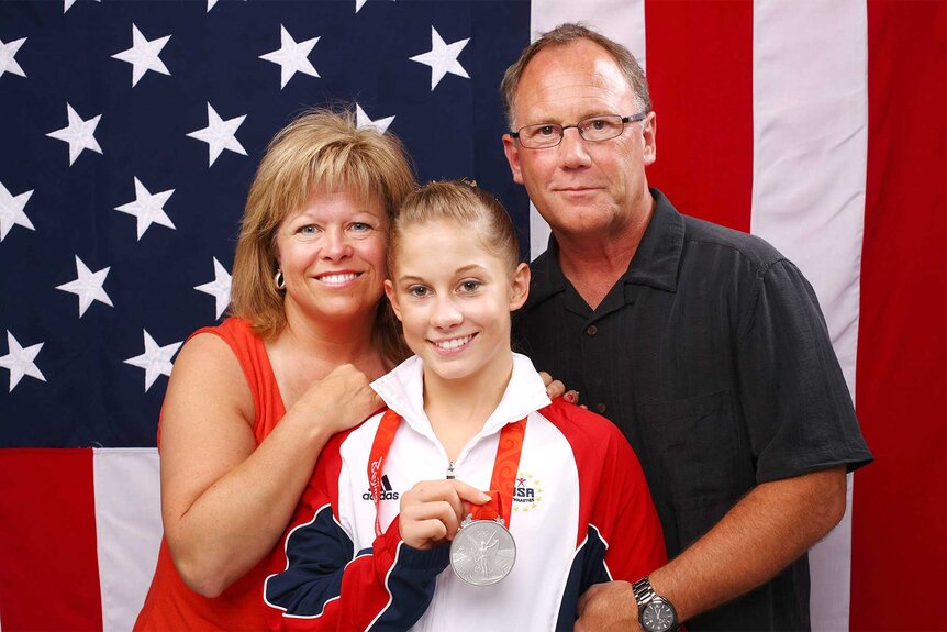 Shawn Johnson stands with her parents after the Women's all around Gymnastics event in 2008