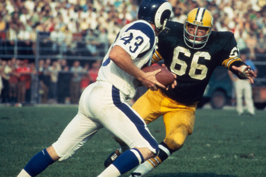 Ray Nitschke #66 of the Green Bay Packers makes eye contact with a Los Angeles Ram and goes in for the tackle