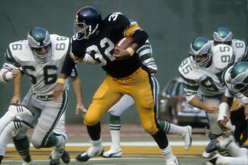 Running back Franco Harris #32 of the Pittsburgh Steelers carries the ball against the Philadelphia Eagles