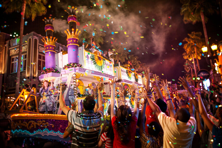 A Universal Orlando Mardi Gras floatmoves down the street