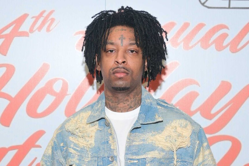 21 Savage wears a denim jacket on the red carpet for the 21 Savage 4th Annual Grant-A-Wish Event