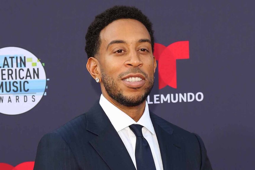 Ludacris smiles in a suit.