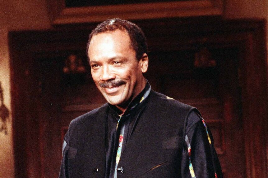 Quincy Jones wears a black outfit.