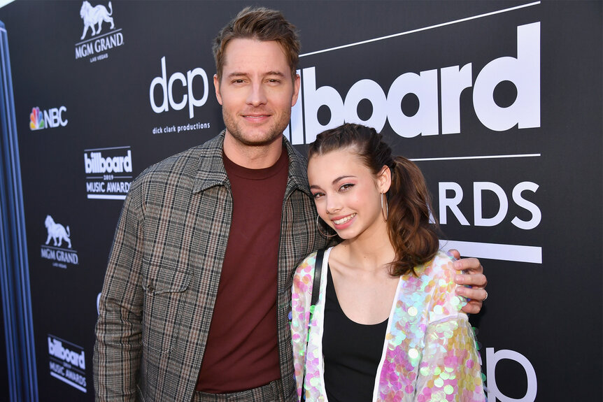 Justin Hartley has his hand on his daughter Isabella Justice Hartley's shoulder on the red carpet