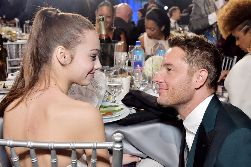 Justin Hartley stares at his daughter Isabella Justice Hartley at the table at the billboard music awards