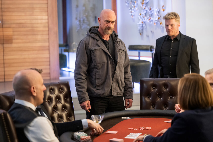 Elliot Stabler and Officer Logan stand at a poker table on Law And Order organized crime Episode 405