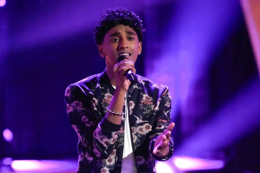 William Alexander sings in a floral jacket in Season 25 Episode 4 of The Voice.