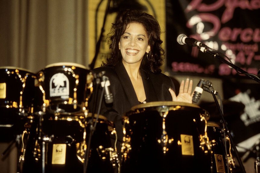 Sheila E performing onstage during a percussion demonstration