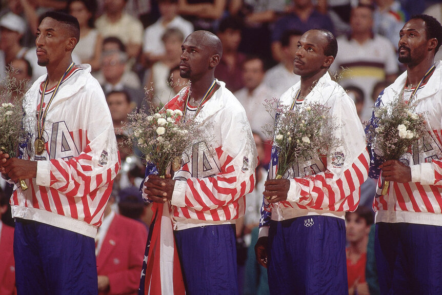 USA Scottie Pippen, Michael Jordan, Clyde Drexler, and Karl Malone stand on the medal stand after winning Olympic gold