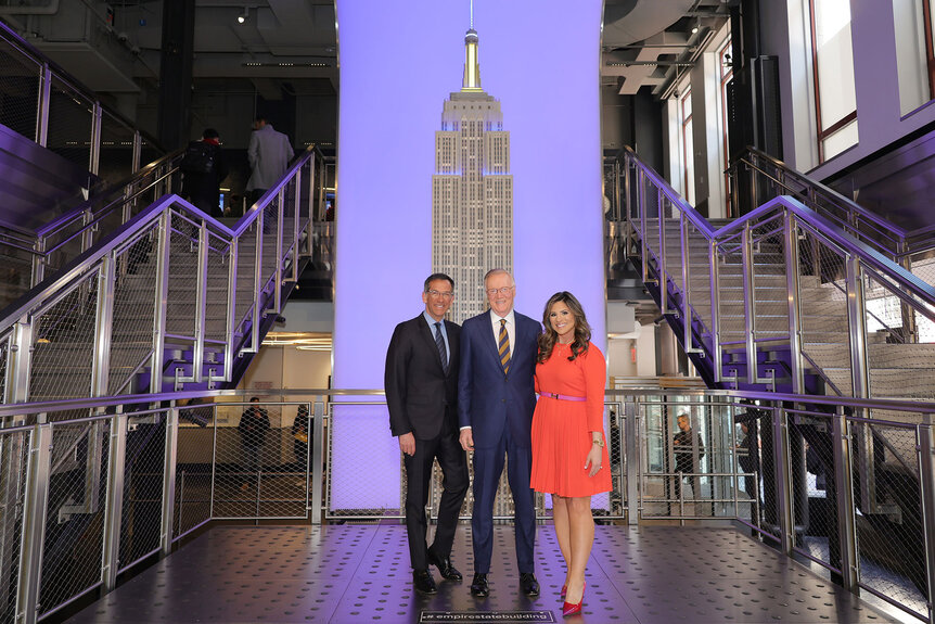 Dave Price, Chuck Scarborough and Natalie Pasquarella pose inside the Empire State building