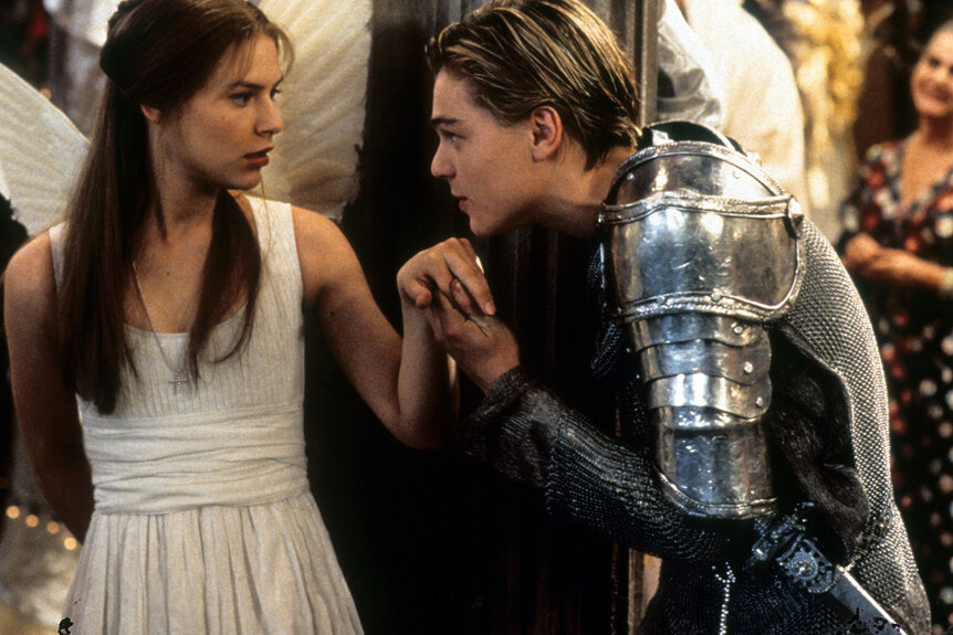 Claire Danes is surprised as Leonardo DiCaprio takes her hand to kiss in scene from the film 'Romeo + Juliet', 1996.