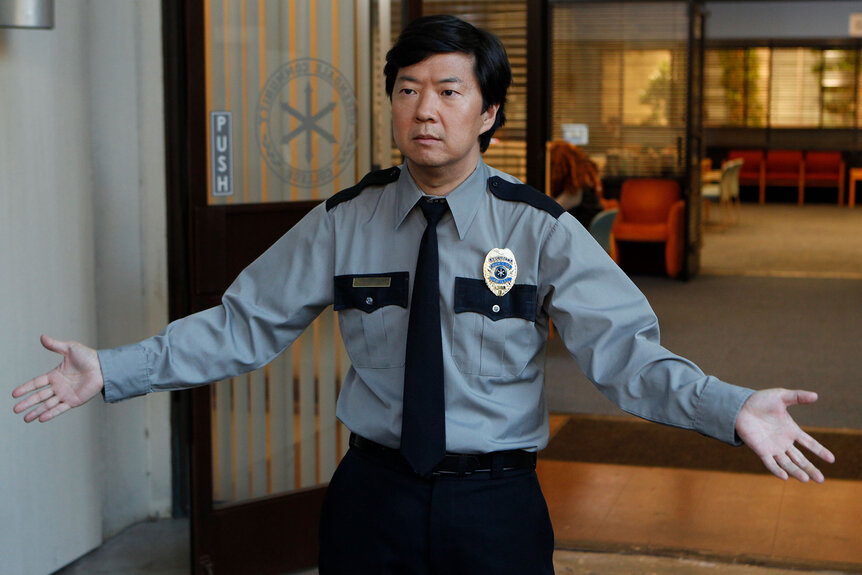 Ben Chang (Ken Jeong) stands with his arms outstretched
