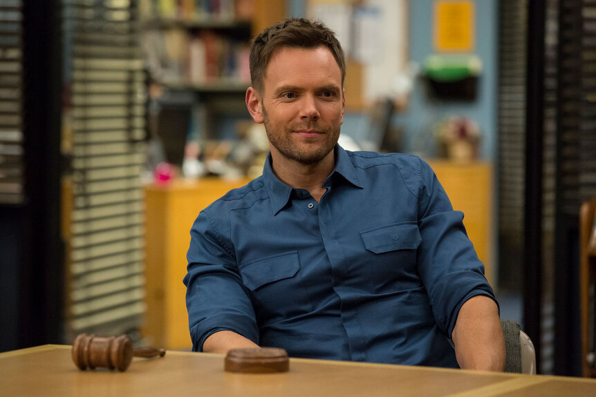 Jeff Winger (Joel McHale) sits an a table with a gavel in front of him