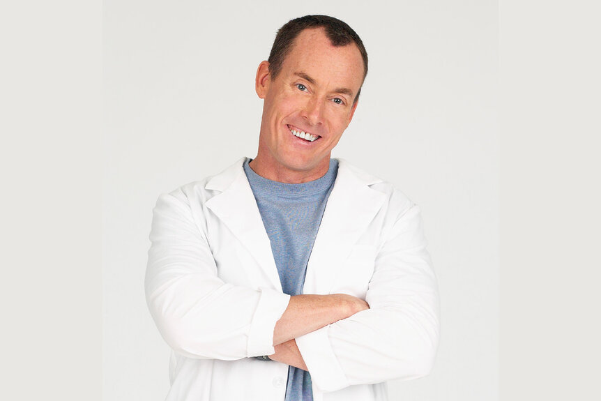 Dr. Perry Cox smiles in Scrubs Season 1.