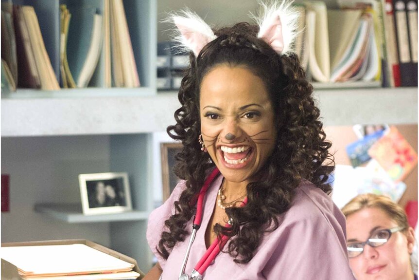 Nurse Carla Espinoza (Judy Reyes) wears cat ears and a drawn on cat nose in Scrubs Season 1 Episode 6.