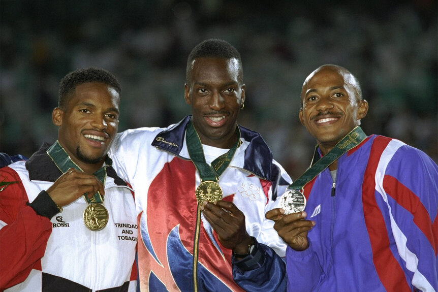 Ato Boldon of Trinidad, gold medallist Michael Johnson of the USA and silver medallist Frankie Fredericks of Namibia pose with their medals on the podium