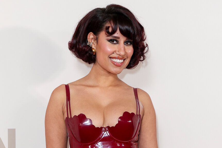 Raye on the red carpet for the GQ Men Of The Year Awards in a red dress