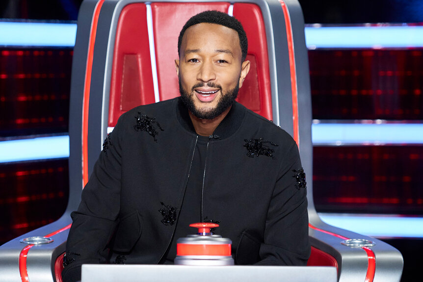 John Legend sits in his coaches chair on The Voice 2508