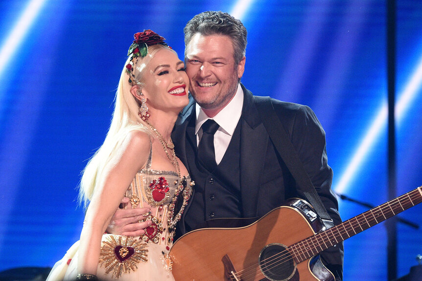 Gwen Stefani and Blake Shelton pose onstage at the GRAMMY Awards