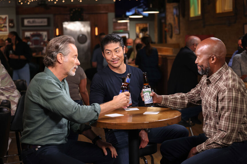 Dean Archer, Ethan Choi, and Gerald Simmons make a toast at Molly's bar during Chicago Med Season 8 Episode 1.
