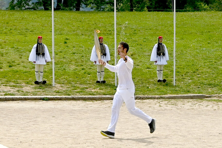 A greek torchbearer during the flame Lighting Ceremony for the Paris 2024 Olympics