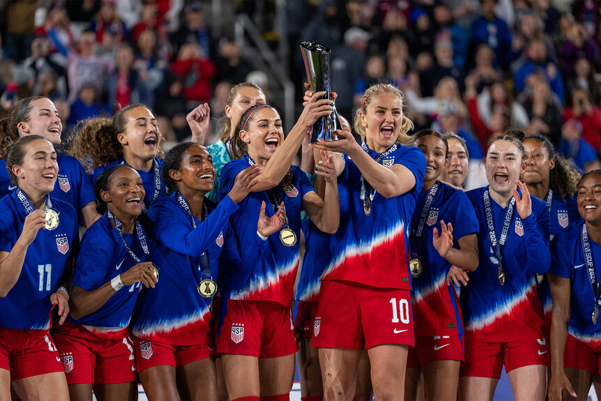 Alex Morgan and Lindsey Horan lift up the SheBelieves Cup trophy after winning