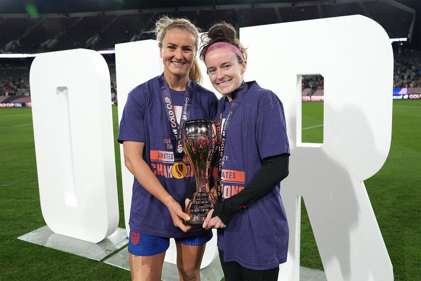 Lindsey Horan and Rose Lavelle pose with the the championship trophy