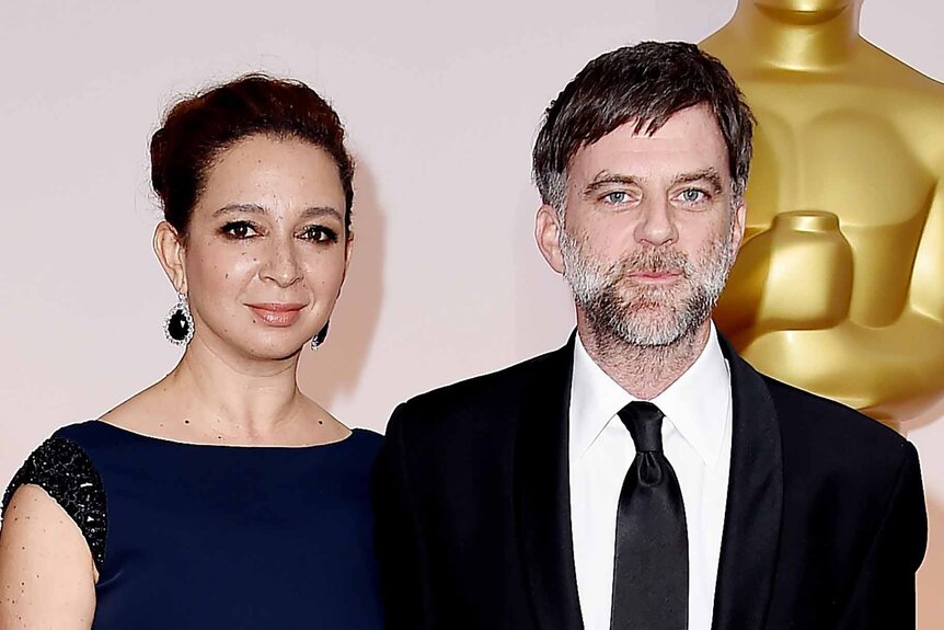 Maya Rudolph and Paul Thomas Anderson smiles together at the 87th Academy Awards.