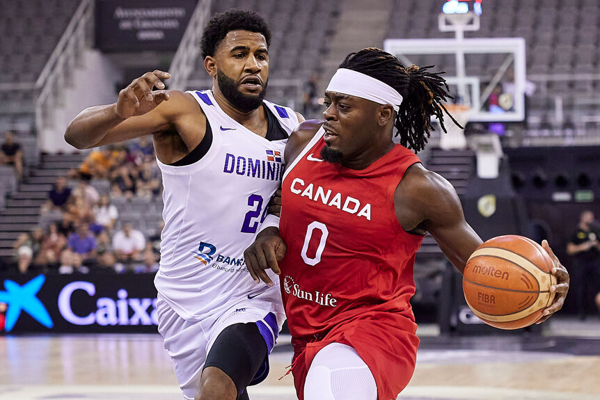 Luguentz Dort of the Canada Men's National Basketball Team competes for the ball with Lionel Figueroa of the Dominican Republic Men's National Basketball Team