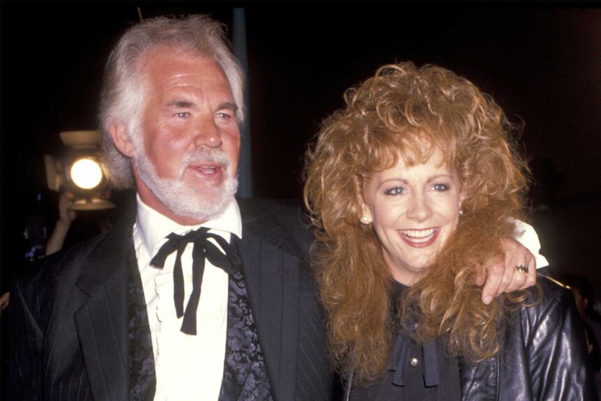 Reba McEntire and Kenny Rogers attend a movie premiere in 1991