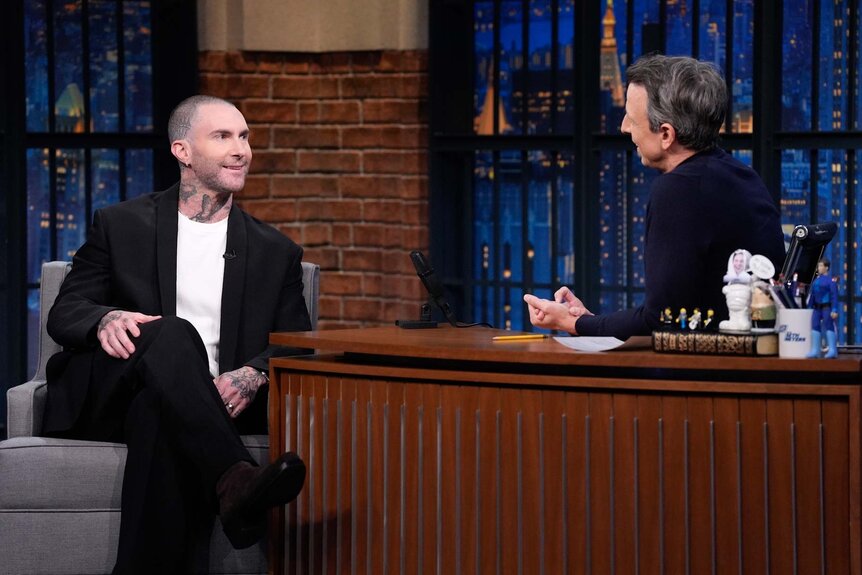 Adam Levine laughs with Seth Meyers on Late Night with Seth Meyers Season 12, Episode 83