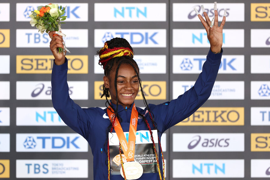 Gold medalist Sha'Carri Richardson of Team United States poses for a photo on the podium during the medal ceremony